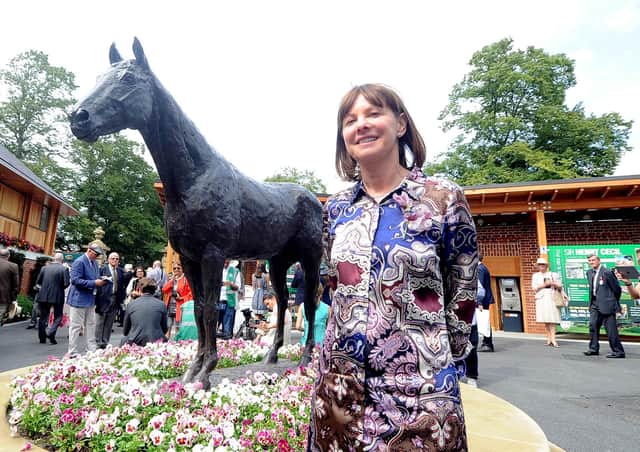 Lady Jane Cecil standing by the statue of Frankel at York.