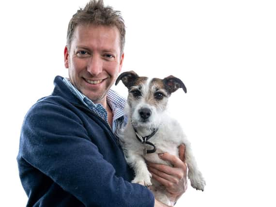 Julian, pictured with his jack russell, Emmy was dealing with emergency surgery