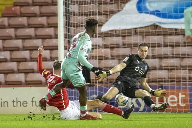 Swansea's Jamal Lowe slots the ball past Tykes keeper Jack Walton  to score after Mads Andersen's mistake.  Picture Tony Johnson