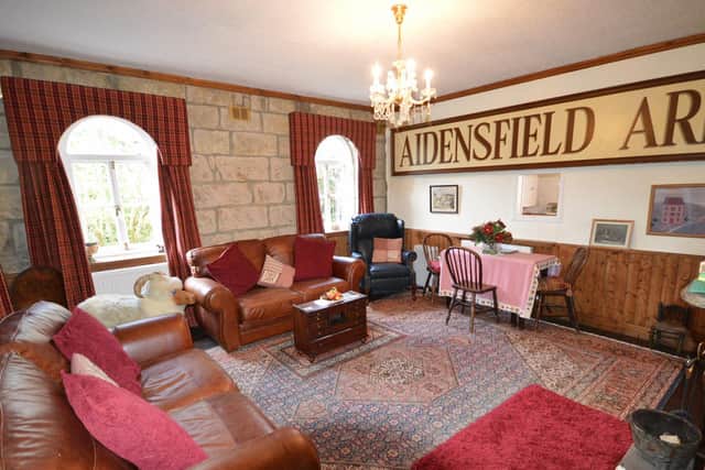 The former waiting room is now a spacious sitting room with original windows and the Aidensfield Arms sign from Heartbeat TV series