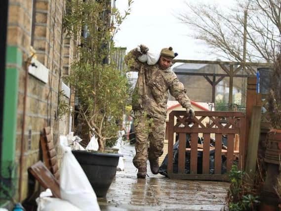 A soldier from The Highlanders, 4th Battalion, the Royal Regiment of Scotland in Mytholmroyd assisting with flood defences, in the Upper Calder Valley in West Yorkshire ahead of Storm Dennis last February. Picture: Danny Lawson/PA Wire.