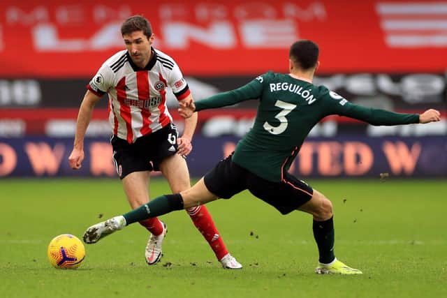 TOUGH TIMES: Sheffield United's Chris Basham battles for the ball against Tottenham Hotspur's Sergio Reguilon at Bramall Lane. Picture: Mike Egerton/PA