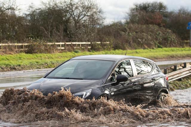Motorists make their way through floodwater on Derby Road in Hathern, Leicestershire, as Storm Christoph hits