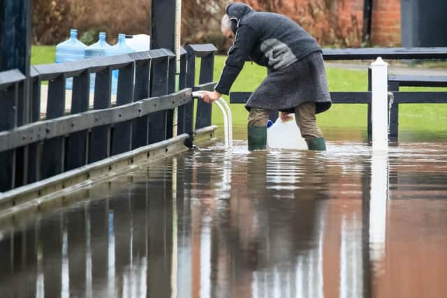 A man in flood water near Naburn Lock Caravan Park in York as Storm Christoph is set to bring widespread flooding, gales and snow to parts of the UK
