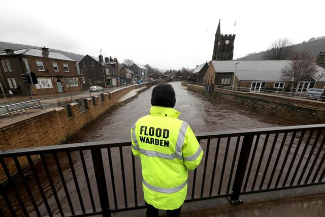 A flood warden looks at the water levels of the River Calder in Mytholmroyd in the Upper Calder Valley, in anticipation of Storm Christoph (Photo: Danny Lawson/PA Wire)