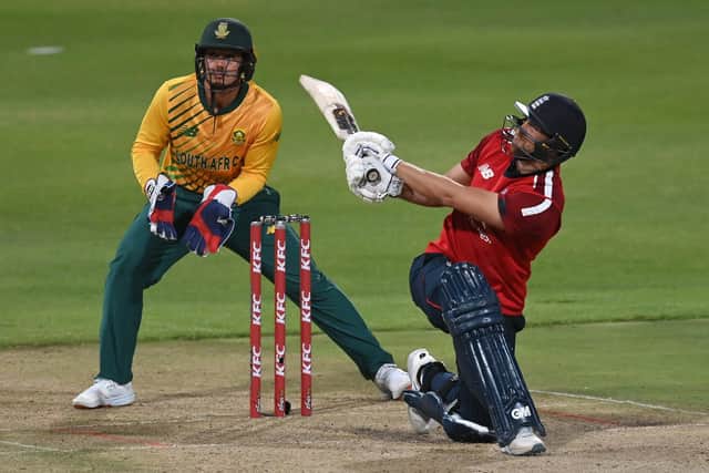 SMASHING IT: England's Dawid Malan sweeps a six as South Africa's Quinton de Kock of looks on during the third Twenty20 International at Newlands in December last year. Picture: Shaun Botterill/Getty Images