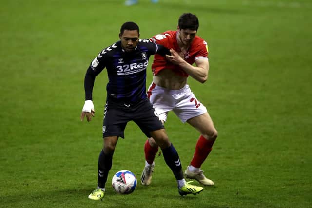 GOAL HERO: Middlesbrough's Britt Assombalonga (left) and Nottingham Forest's Scott McKenna battle for the ball at the City Ground. Picture: Tim Goode/PA