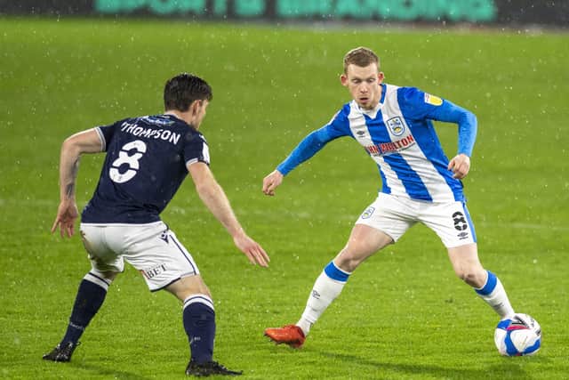 BAD NIGHT: Huddersfield Town's Lewis O'Brien takes on Millwall's Ben Thompson.  Picture: Tony Johnson