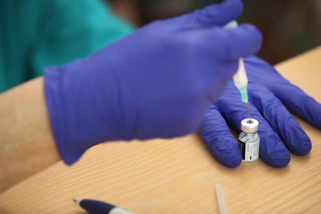 A nurse prepares the BioNTech/Pfizer Covid-19 vaccine for doctors to inject into elderly residents arms at Bowbrook House care home in Shrewsbury. Photo: PA