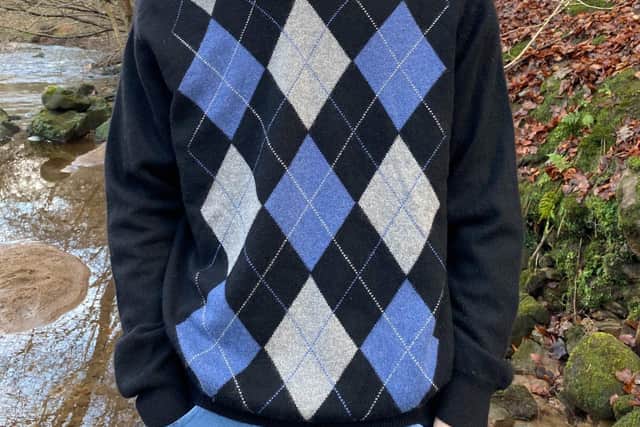 Ali’s son Hugh Hollins wears argyle pattern cashmere sweater