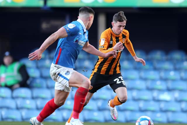 Portsmouth's Callum Johnson (left) and Hull City's Gavin Whyte battle for the ball at Fratton Park. Picture: Kieran Cleeves/PA