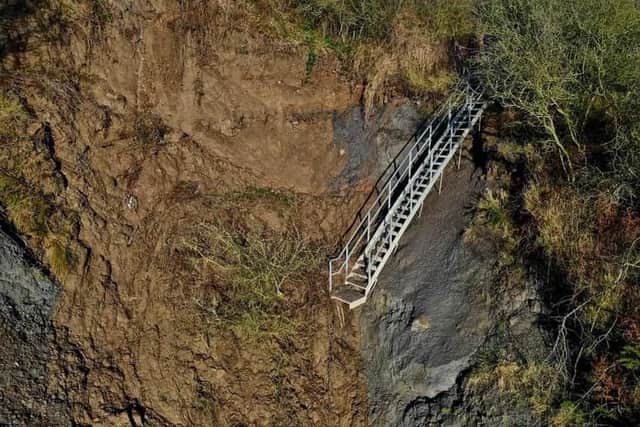 The stairs to Port Mulgrave beach have been severed by the landslide
