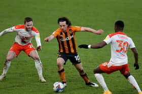 Hull City's George Honeyman (centre), Blackpool's Bez Lubala (right) and Oliver Turton in action during the League One match at the KCOM. Picture: Richard Sellers/PA.