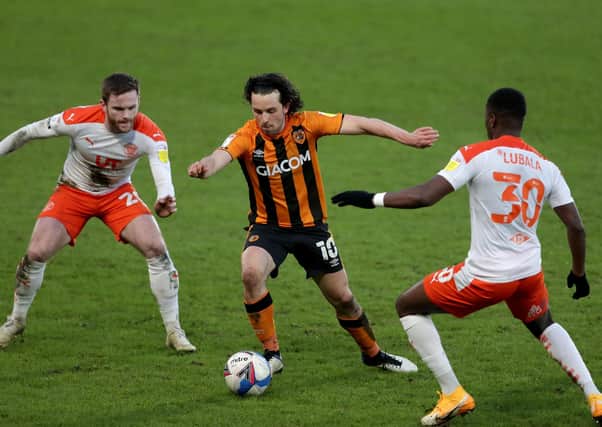 Hull City's George Honeyman (centre), Blackpool's Bez Lubala (right) and Oliver Turton in action during the League One match at the KCOM. Picture: Richard Sellers/PA.
