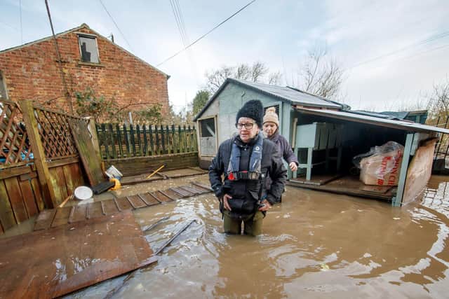 Denise Munday (left) and Ruth Richards (right) check on Ruth's rescued ex-battery hens, in flood water at her home near Naburn Lock in York following heavy rain during Storm Christoph. Photo: PA