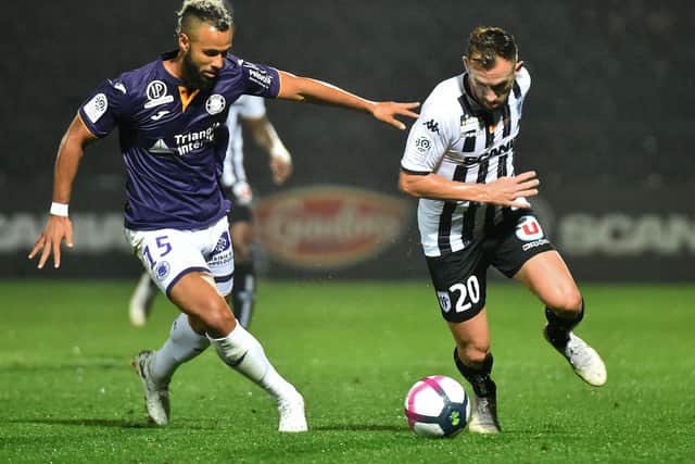 INCOMING: Midfielder John Bostock, left, vies with Angers' Flavien Tait while playing for Toulouse in September 2018,. Picture: JEAN-FRANCOIS MONIER/AFP via Getty Images
