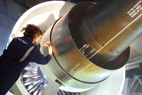 Rolls-Royce photo of a female worker inspecting a Trent 1000 engine.