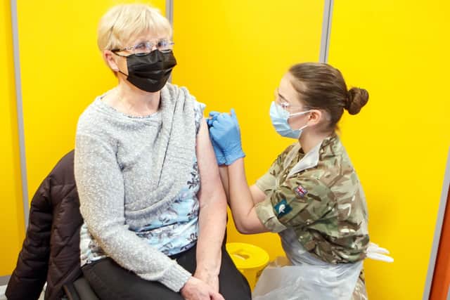 Diane Slack receives an injection of the coronavirus vaccine from a Ministry of Defence (MoD) employee at West Yorkshire's first large vaccination centre set up at Spectrum Community Health CIC, in Wakefield.