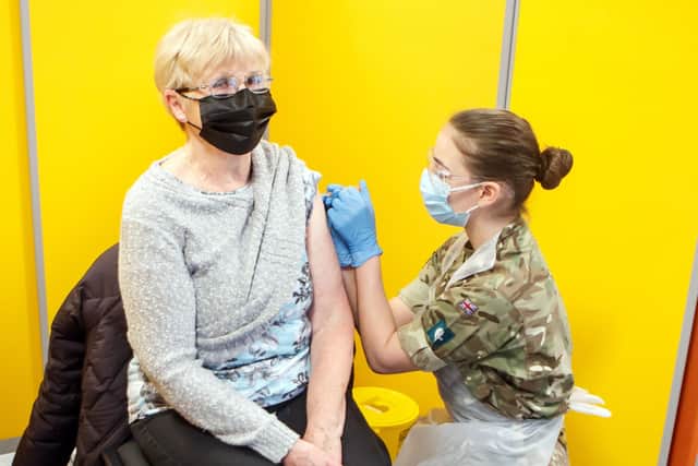 Diane Slack receives an injection of the coronavirus vaccine from a Ministry of Defence (MoD) employee at West Yorkshire's first large vaccination centre set up at Spectrum Community Health CIC, in Wakefield.
