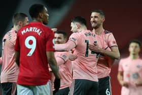 Can you believe it: Oliver Burke, centre, is mobbed by his Sheffield United team-mates after his goal stunned Anthony Martial, left, and Manchester United. (Picture: Simon Bellis/sport Image)