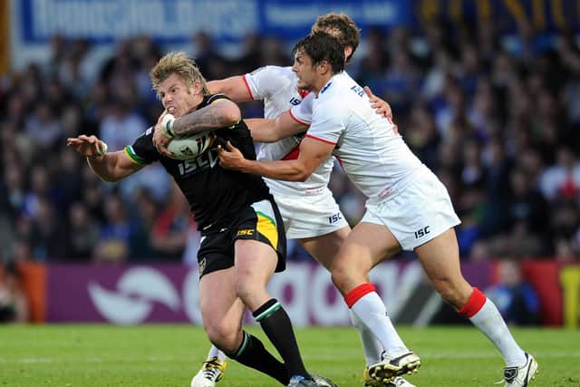 CAP THAT: Glenn Morrison, left, is tackled by Jon Wilkin in the clash between England and the Exiles at Headingley in 2011. Picture: Chris Brunskill/Getty Images.