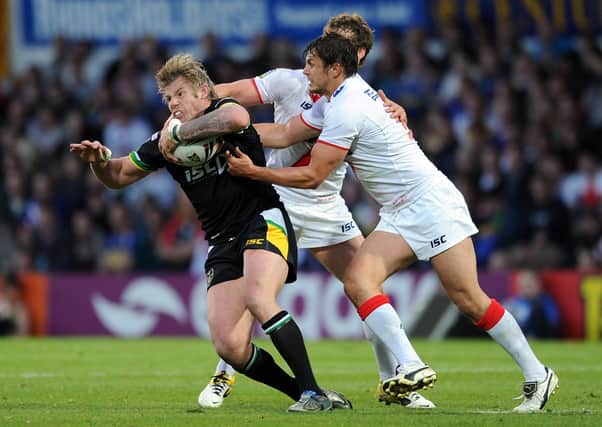 CAP THAT: Glenn Morrison, left, is tackled by Jon Wilkin in the clash between England and the Exiles at Headingley in 2011. Picture: Chris Brunskill/Getty Images.