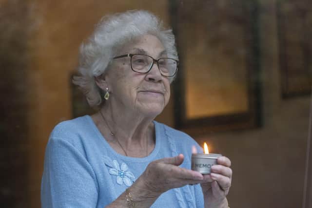 Liesel Carter, 85, lights a candle at her window for Holocaust Memorial Day. She fled Nazi Germany when was 4 in 1939, pictured in Leeds.