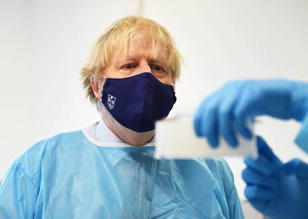 Prime Minister Boris Johnson is shown the Lighthouse Laboratory, used for processing polymerase chain reaction (PCR) samples for coronavirus, during a visit to the Queen Elizabeth University Hospital campus in Glasgow.