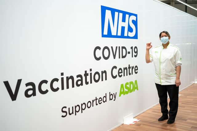 Handout photo issued by Asda of a qualified Asda pharmacy colleague holding a dose of the coronavirus vaccine at an Asda in West Bromwich.