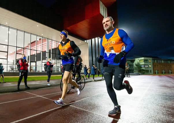 RUNNING MAN: Jamie Peacock joins Kevin Sinfield during last month's '7 in 7', running along the track at the new Leeds Beckett Sports facility. Picture by Allan McKenzie/SWpix.com