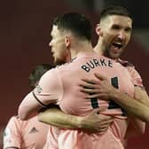Sheffield United's Oliver Burke (left) celebrates with Chris Basham after scoring the winning goal at Manchester United (Picture: PA)