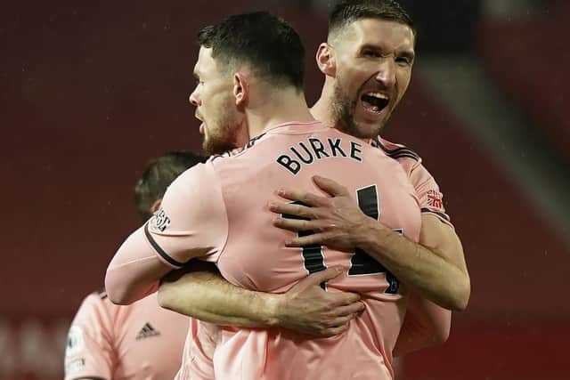 Sheffield United's Oliver Burke (left) celebrates with Chris Basham after scoring the winning goal at Manchester United (Picture: PA)