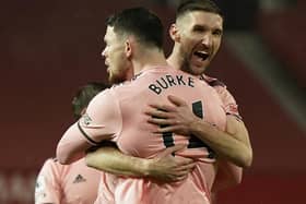 Sheffield United's Oliver Burke (left) celebrates with Chris Basham after scoring the winning goal at Manchester United (Picture: PA)