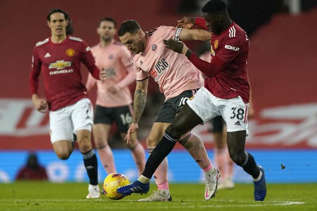 Sheffield United's Billy Sharp (left) and Manchester United's Axel Tuanzebe battle for the ball (Picture: PA)