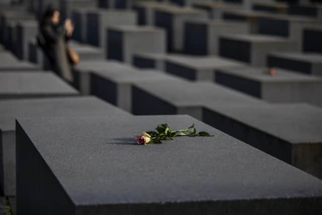Roses are placed on the Holocaust Memorial on the International Holocaust Remembrance Day on January 27, 2021 in Berlin.