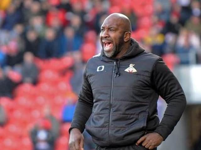 Doncaster Rovers boss Darren Moore, who has completed his fourth signing in a week after bringing in Celtic teenager Scott Robertson on loan.