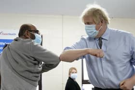 Prime Minister Boris Johnson elbow bumps Ismail Patel after getting his jab during  a visit to a coronavirus vaccination centre in Batley, West Yorkshire.