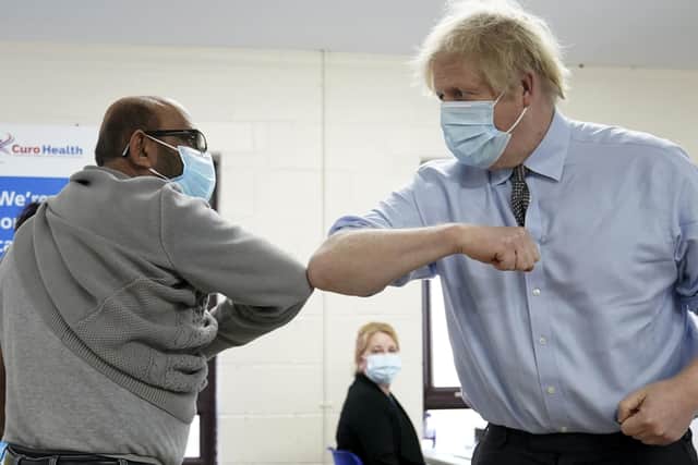 Prime Minister Boris Johnson elbow bumps Ismail Patel after getting his jab during  a visit to a coronavirus vaccination centre in Batley, West Yorkshire.