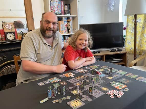 Dan and Cora Hughes with their boardgame. (Credit: SWNS)