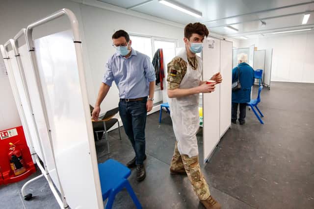 A member of the military provides assistance in the vaccination centre at Askham Bar park-and-ride in York.