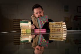 Dr John Atkinson pictured with his collection of Ian Fleming James Bond books. Picture by Simon Hulme.