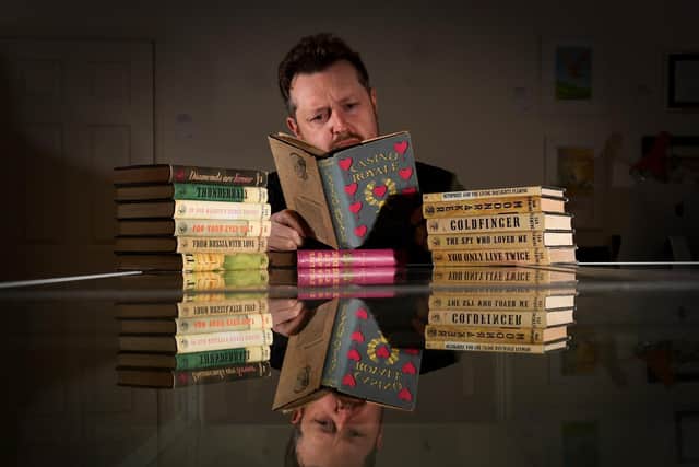 Dr John Atkinson pictured with his collection of Ian Fleming James Bond books. Picture by Simon Hulme.