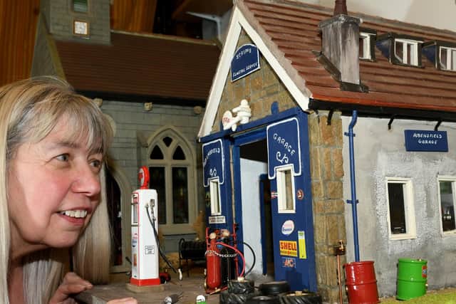 Pauline Millard from Weaverthorpe Dolls Houses and Miniatures at Weaverthorpe near Malton. with the handmade model of Scripps Garage in the TV series Heartbeat the real one being at Goathland. Image: Gary Longbottom