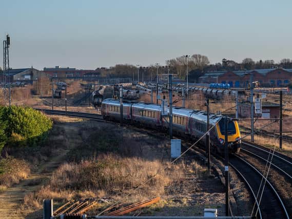 A train arrives at York railway station, with part of the sprawling York Central brownfield site in the background. A planning application for a re-development of the station's entrance and a re-modelled public transport interchange has been recommended for approval, and will be discussed by councillors. (Picture: James Hardisty)