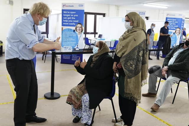 Prime Minister Boris Johnson gives a thumbs up to patients after they were given the vaccine during a visit to a coronavirus vaccination centre in Batley, West Yorkshire. Photo: PA