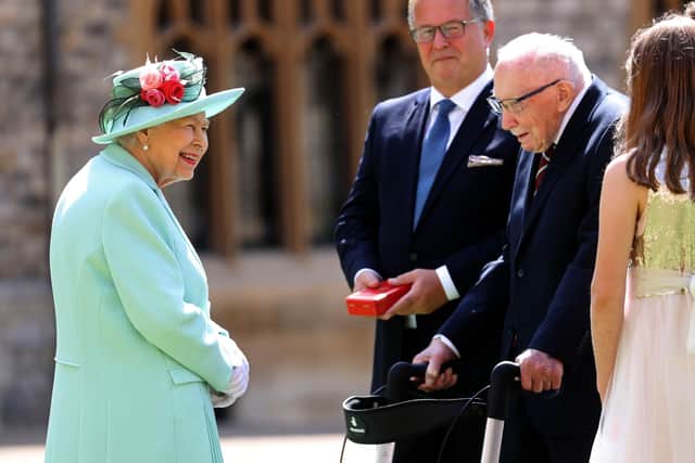 This was the Queen talking to Captain Sir Tom Moore in the grounds of Windsor Castle after a special investiture ceremony.