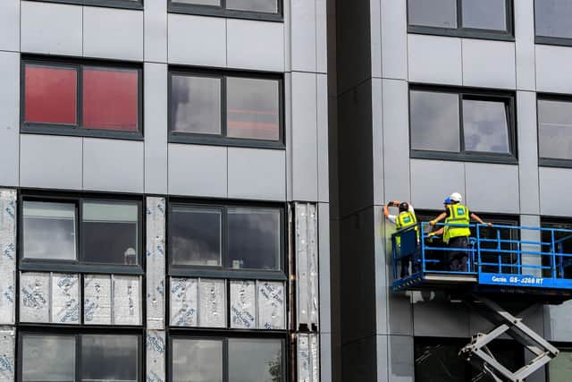 Who should be financially liable for cladding faults and repairs?