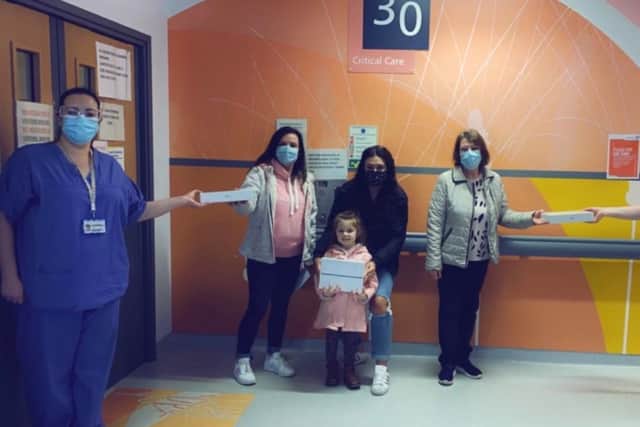 The Meehan family handing over the iPads to the hospital staff