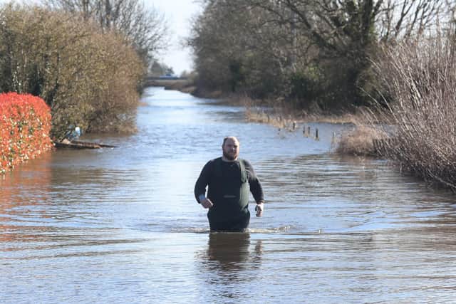 Stuart Smith, a volunteer from Somerset standing in the floodwaters of East Cowick, Yorkshire.