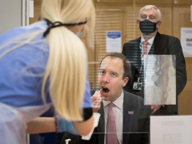 Health Secretary Matt Hancock takes a coronavirus test at a new Covid-19 testing facility in the Houses of Parliament in London watched by the Speaker of the House of Commons, Sir Lindsay Hoyle. Picture: Stefan Rousseau/PA Wire